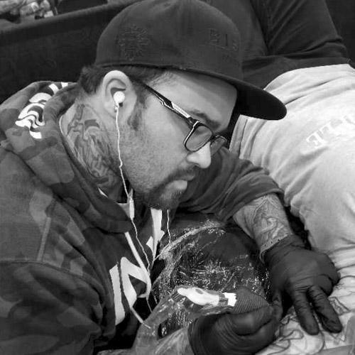 Tattoo artist in New York using FYT tattoo supplies and premium tattoo needles on client