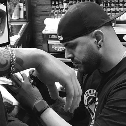 Tattoo artist using FYT tattoo supplies at work in New York studio