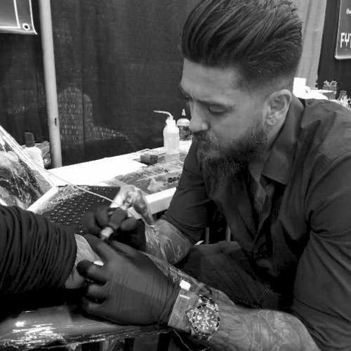 Tattoo artist using FYT tattoo supplies and cartridges on client in New York studio