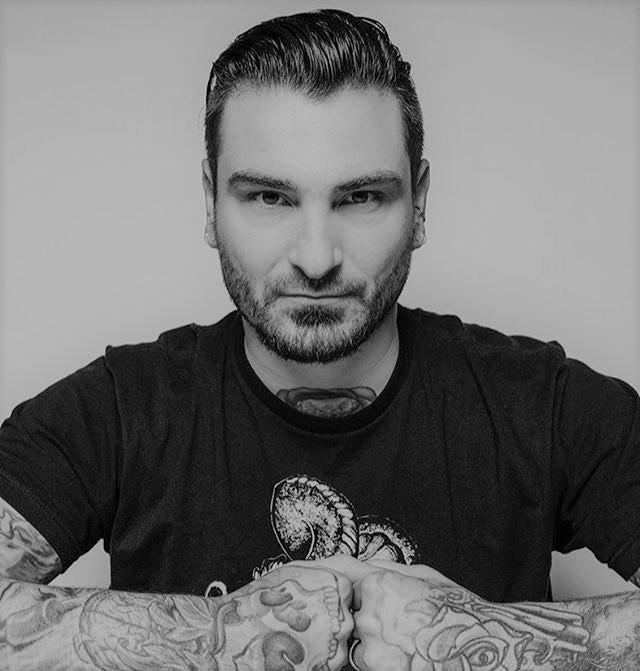 Tattooed man in black shirt posing, promoting FYT Tattoo Supplies New York