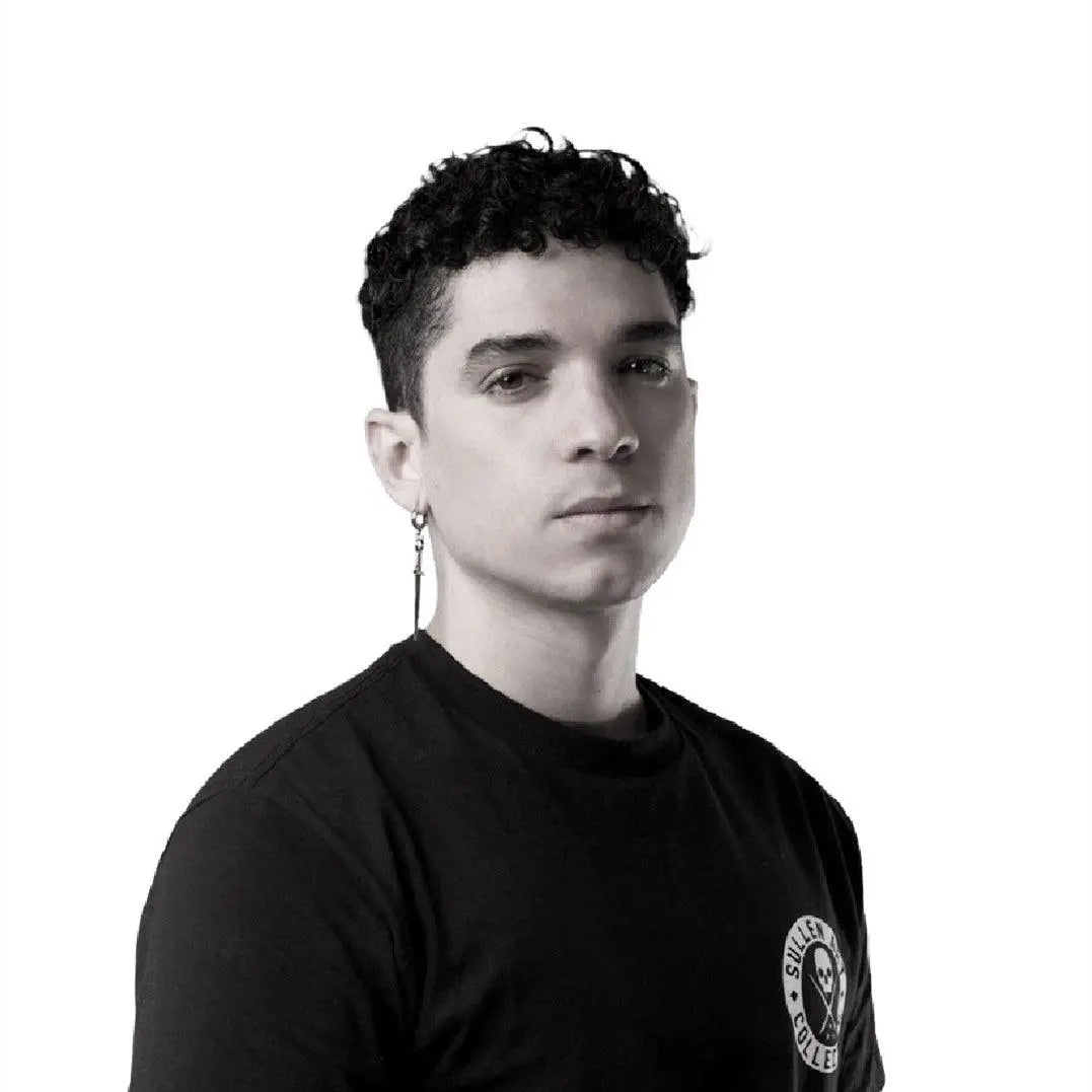 Tattoo artist in black Sullen Collective shirt, FYT Tattoo Supplies New York studio style
