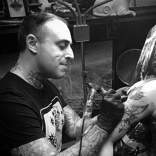 Tattoo artist using FYT tattoo supplies on client's arm in New York studio